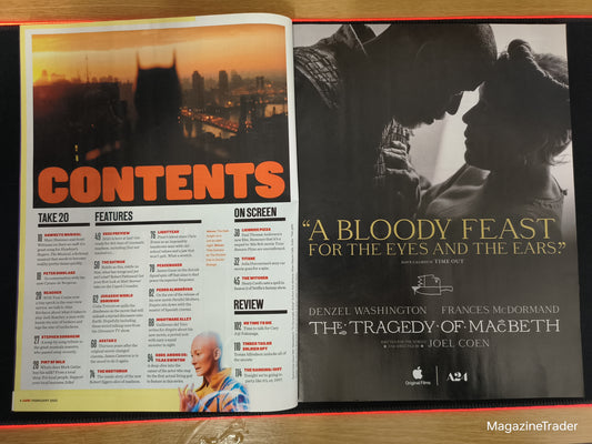 Open magazine with movie poster and contents page on a wooden surface